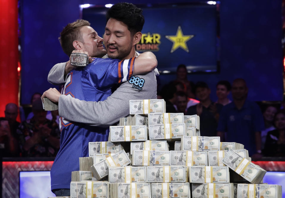 Tony Miles, left, embraces first place finisher John Cynn after the World Series of Poker main event in Las Vegas. (AP Photo)