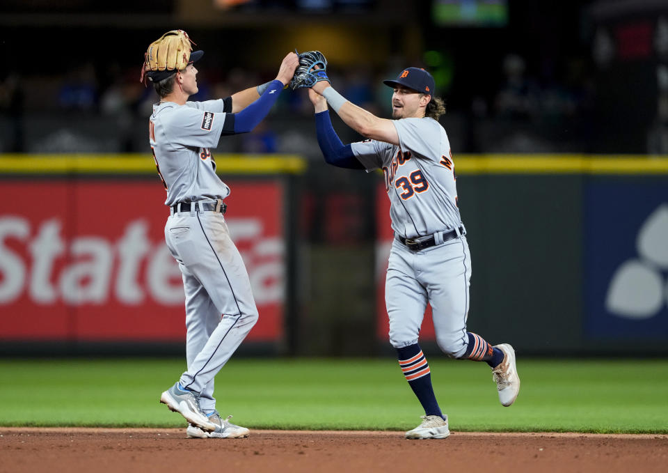 Detroit Tigers second baseman Nick Maton, left, greets Zach McKinstry after the team's 5-4 win over the Seattle Mariners in a baseball game Friday, July 14, 2023, in Seattle. (AP Photo/Lindsey Wasson)