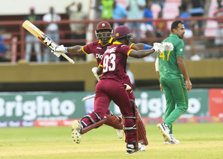 Wahab Riaz (R) of Pakistan walks off the field as Ashley Nurse (L) and Jason Mohammed (C) of West Indies celebrate winning the 1st ODI match at Guyana National Stadium, Providence, Guyana, on April 7, 2017