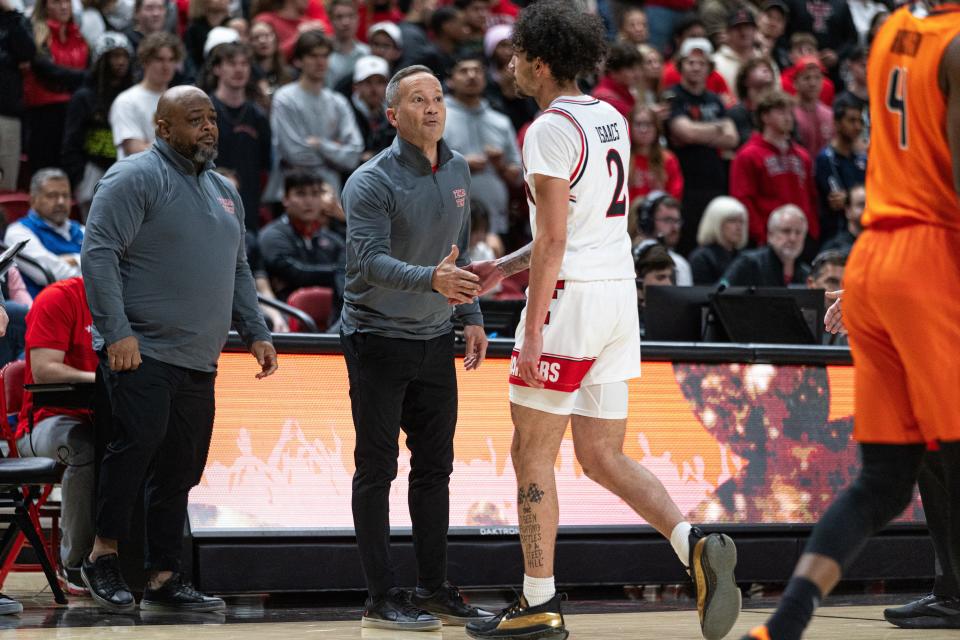 Texas Tech head coach Grant McCasland pumps up Pop Isaacs during a game against Oklahoma State in a Big 12 conference basketball game, Tuesday, Jan. 9, 2024, at United Supermarkets Arena.