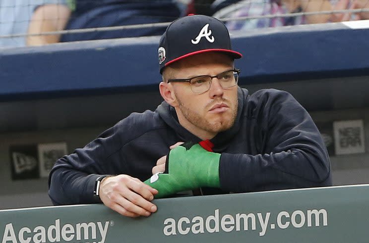 Injured Atlanta Braves first baseman Freddie Freeman (5) wears a cast on his wrist as he watches a baseball game against the Toronto Blue Jays Thursday, May 18, 2017, in Atlanta. Freeman was hit by a pitch the pervious night and is expected to miss up to ten weeks. (AP Photo/John Bazemore)