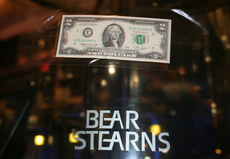 FILE PHOTO: A U.S. two dollar bill is taped to the revolving door leading to the Bear Stearns global headquarters in New York, U.S., March 17, 2008. REUTERS/Kristina Cooke/File Photo