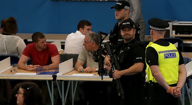 Armed police patrol the hall ahead of the General Election count at Silksworth Community Centre in Sunderland. Picture: AAP