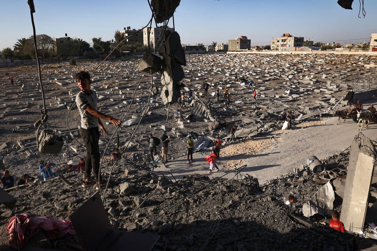 A Palestinian child boy stands on what remains of a balcony of a flat hit by overnight Israeli bombing in Rafah (AFP via Getty Images)