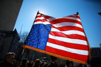 <p>A protester waves a flag during the “Mock Funeral for Presidents’ Day” rally at Washington Square Park in New York City on Feb. 18, 2017. (Gordon Donovan/Yahoo News) </p>