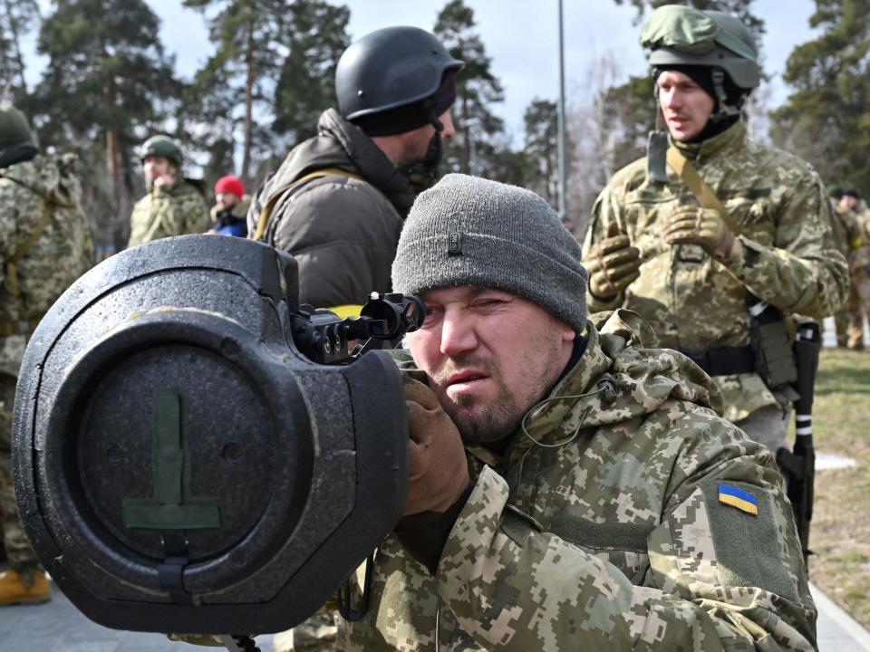 A Ukrainian soldier examines a shoulder-fired anti-tank rocket.