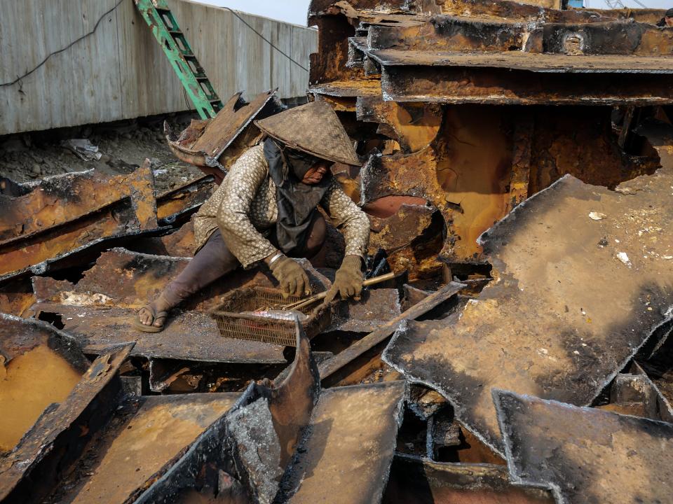 A worker gains a metal from a demolished old ships at a shipbreaking yards Kalibaru in Jakarta, Indonesia on September 27, 2018.