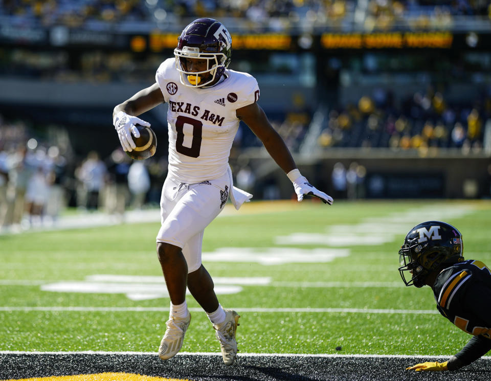 Oct 16, 2021; Columbia, Missouri, USA; Texas A&M Aggies wide receiver Ainias Smith (0) scores a touchdown against Missouri Tigers defensive back <a class="link " href="https://sports.yahoo.com/nfl/players/34074" data-i13n="sec:content-canvas;subsec:anchor_text;elm:context_link" data-ylk="slk:Akayleb Evans;sec:content-canvas;subsec:anchor_text;elm:context_link;itc:0">Akayleb Evans</a> (26) during the first half at Faurot Field at Memorial Stadium. Mandatory Credit: Jay Biggerstaff-USA TODAY Sports
