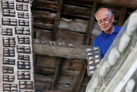 Stone collector Luigi Lineri, 79, looks at his collection of stones found along Adige river, at his home workshop in Zevio, near Verona, Italy, June 10, 2016. REUTERS/Alessandro Bianchi