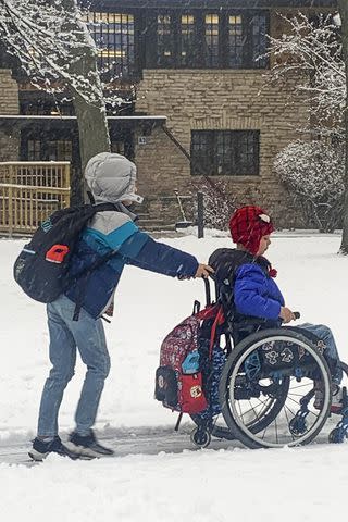 <p>Courtesy Keely Roberts</p> Luke Roberts pushing twin brother Cooper to school