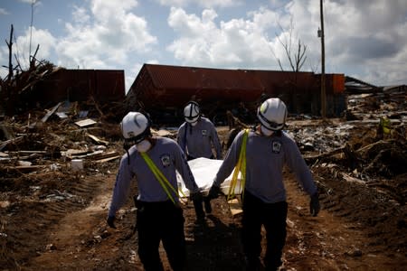 Personnel from the Florida Search & Rescue Task Force remove a body recovered in the destroyed the Mudd neighbourhood after Hurricane Dorian hit the Abaco Islands in Marsh Harbour