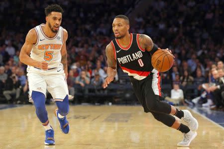 Nov 27, 2017; New York, NY, USA; Portland Trailblazers point guard Damian Lillard (0) drives against New York Knicks shooting guard Courtney Lee (5) during the third quarter at Madison Square Garden. Mandatory Credit: Brad Penner-USA TODAY Sports