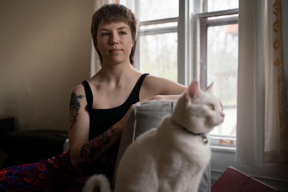 Leah Wathen, 23, sits with her cat named Firefly at her home in Kalamazoo on Sunday, March 26, 2023. "I didn't know who I was for so long. I was very shy and reserved, so a lot of things were just passed off as, 'oh, she's just anxious and quirky,' " said Wathen, who was diagnosed with autism at the age of 22. "When you think of autism you think of the stereotypical child, so I never had any idea it could look like other things. Now I can ask myself, 'how can I be more authentic so that I'm not trying to be someone I'm not all the time.' "