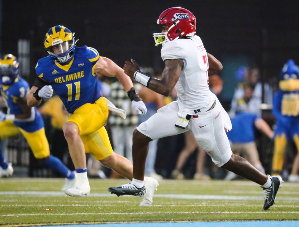 Delaware's Liam Trainer moves for Delaware State quarterback Jared Lewis in the second quarter at Delaware Stadium, Saturday, Sept. 10, 2022.