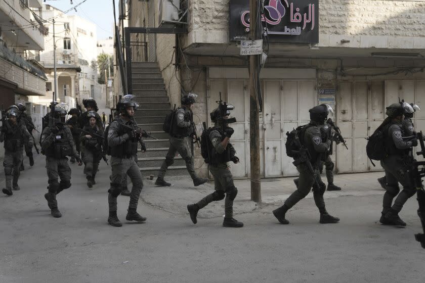 CORRECTS LOCATION Israeli paramilitary Border Police deploy during clashes following the demolition of the family home of Palestinian gunman Uday Tamimi, on the edge of the Shuafat refugee camp in east Jerusalem, Wednesday, Jan. 25, 2023. Israeli forces on Wednesday demolished the home of Tamimi, who allegedly killed a female Israeli soldier in an attack last year that sparked a manhunt and clampdown in the east Jerusalem neighborhood. (AP Photo/ Mahmoud Illean)