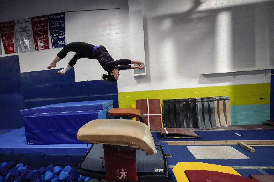 Former gymnastics world champion and Olympic silver medalist Chellsie Memmel works out Thursday, Feb. 18, 2021, in New Berlin, Wisc. Memmel started doing gymnastics again when the COVID-19 pandemic hit last spring because it felt like one of the few things in her life she could control. (AP Photo/Morry Gash)