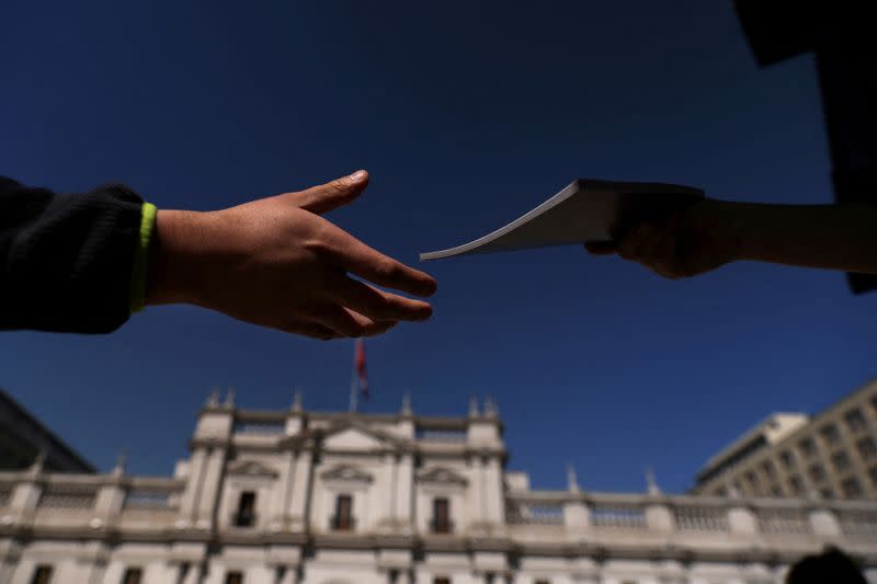 FILE PHOTO: A citizen receives a copy of the proposed new Chilean constitution in Santiago