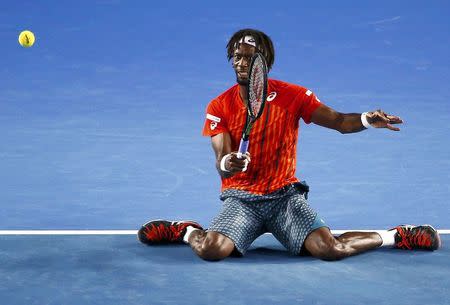 France's Gael Monfils hits a shot on his knees during his quarter-final match against Canada's Milos Raonic at the Australian Open tennis tournament at Melbourne Park, Australia, January 27, 2016. REUTERS/Jason O'Brien Action Images via Reuters