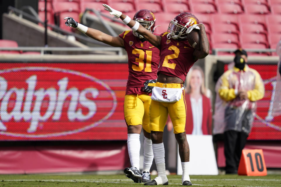 Southern California linebacker Hunter Echols (31) and cornerback Olaijah Griffin (2) celebrate after they thought they recovered a fumble against Arizona State during the first half of an NCAA football game Saturday, Nov. 7, 2020, in Los Angeles. Arizona offense recovered the fumble and there was no turnover. (AP Photo/Ashley Landis)