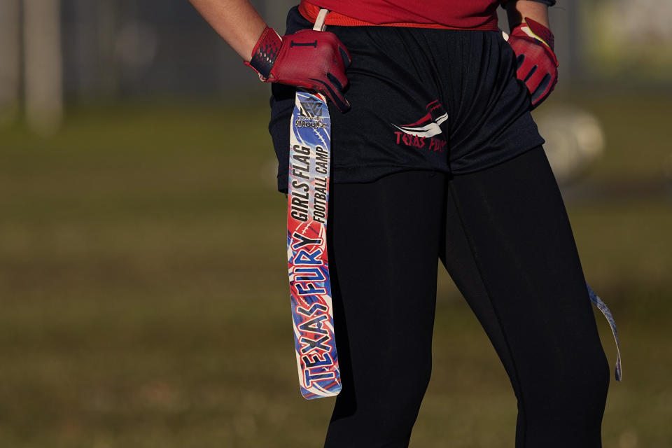 A player holds her belt and flag during a practice with Texas Fury, an all-girls flag football select travel team, Sunday, Dec. 10, 2023, in Austin, Texas. Flag football's inclusion in the 2028 Summer Olympics in Los Angeles only enhances the profile of a sport that's growing by leaps and bounds on the women's side. (AP Photo/Eric Gay)