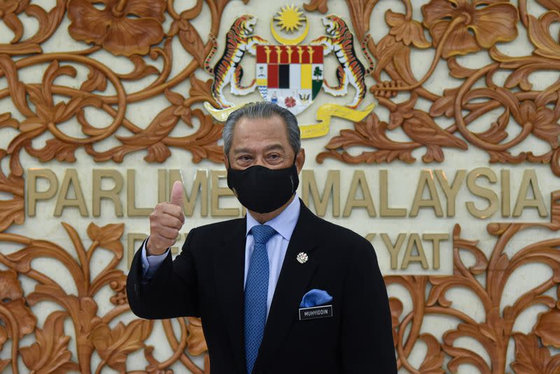 FILE PHOTO: Malaysia's Prime Minister Muhyiddin Yassin poses for a picture at the parliament, in Kuala Lumpur