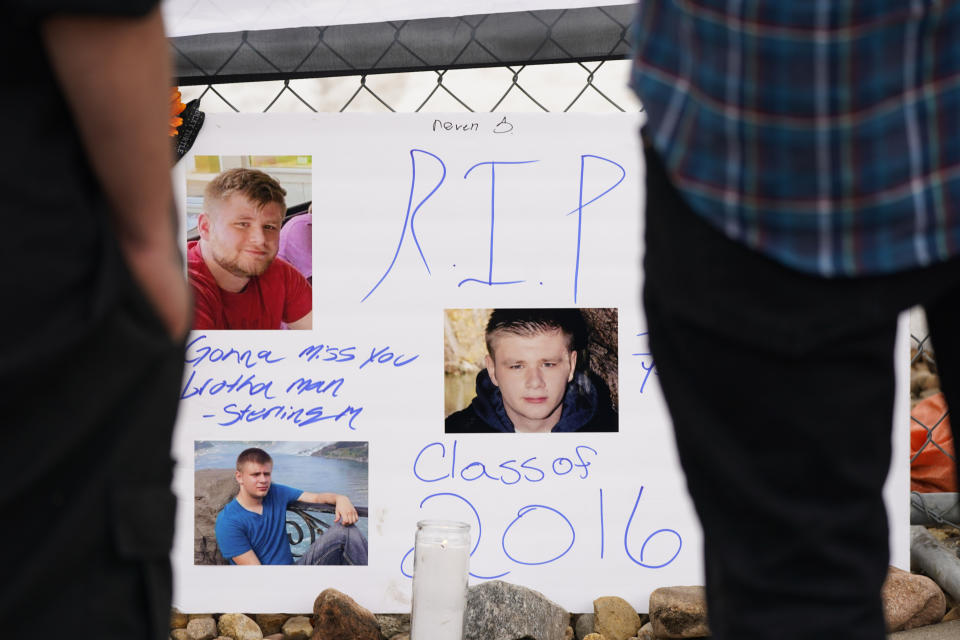 A sign stands in tribute to Neven Stanisic, one of the victims of a mass shooting, on the temporary fence around a King Soopers grocery store, where 10 people died Monday in an attack, Wednesday, March 24, 2021, in Boulder, Colo. (AP Photo/David Zalubowski)