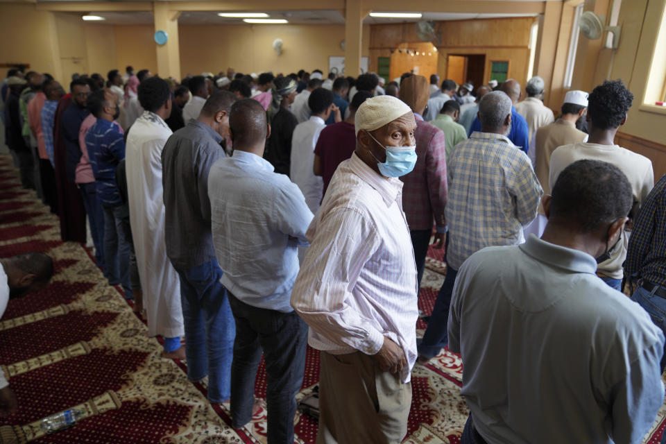 Ahmad Abdi looks toward the back of the mosque during Friday prayer at the Dar Al-Hijrah in Minneapolis on Thursday, May 13, 2022. During the pandemic lockdown in spring 2020, the mosque was given a special permit to broadcast the prayer for the Muslim holy month of Ramadan. That led to a recent resolution authorizing mosques to broadcast the adhan three times a day. (AP Photo/Jessie Wardarski)