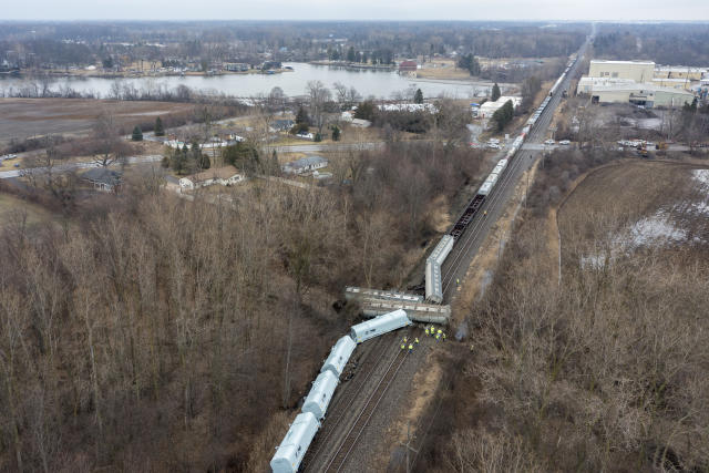 An emergency crew works at the site of a Norfolk Southern train derailment in Van Buren Township, Mich., near Detroit, on Thursday, Feb. 16, 2023. (Andy Morrison/Detroit News via AP)