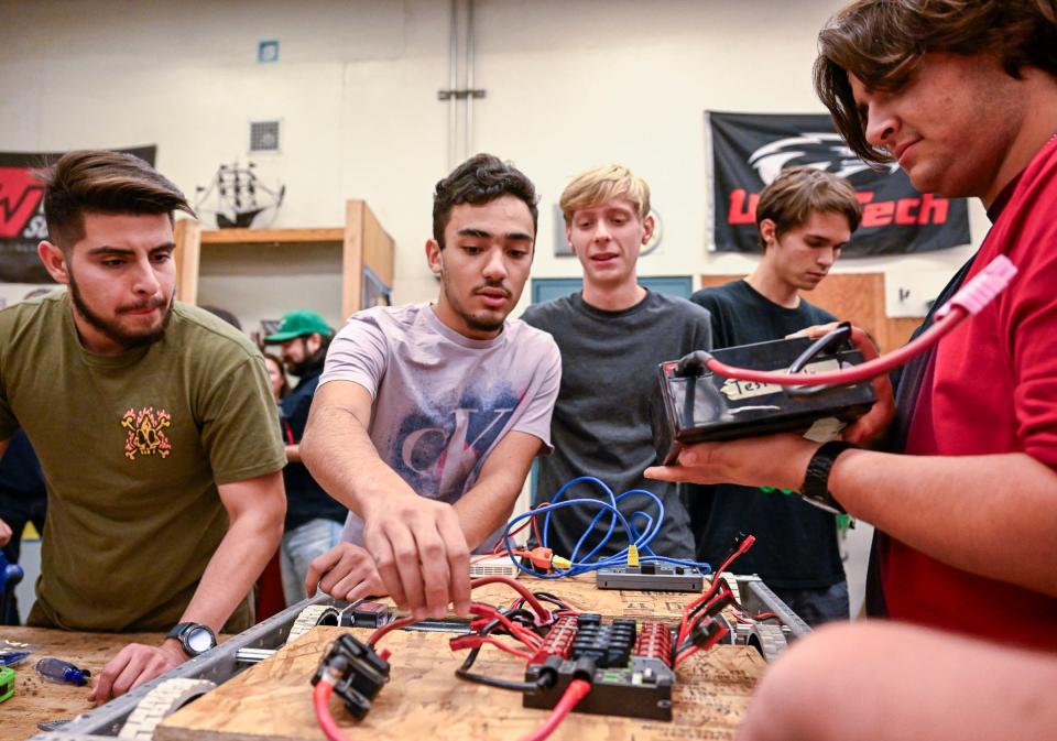 Redwood students Jace Ortiz, left, Andrew Mikhael, and Dominic Mascia, right, work after school with University Preparatory High School students on a robotics project Wednesday, November 15, 2023. Redwood High School’s Robotics team will compete in the Central Valley Regional at the Fresno Fairgrounds thanks to a $6,000 NASA grant.