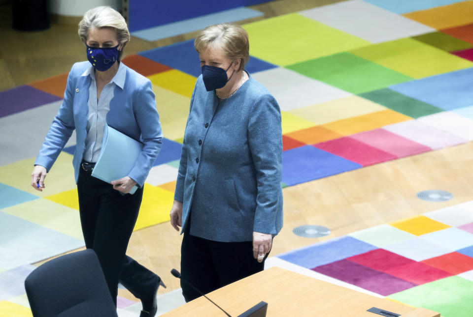 German Chancellor Angela Merkel, right, walks with European Commission President Ursula von der Leyen during a round table meeting at an EU summit in Brussels, Tuesday, May 25, 2021. European Union leaders gather for a second day of meetings to discuss the coronavirus pandemic and to assess new measures on how to meet targets to become climate-neutral by mid-century. (AP Photo/Olivier Matthys, Pool)