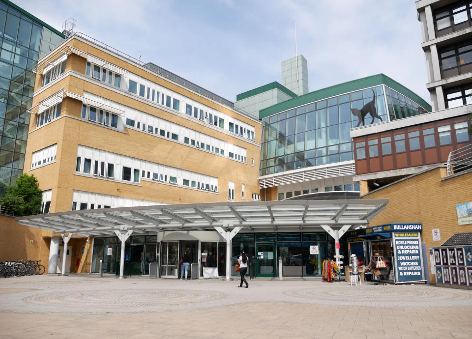 London, UK - June 9, 2014: Visitors making their way to the main entrance to the Whittington Hospital on Highgate Hill in North London.  