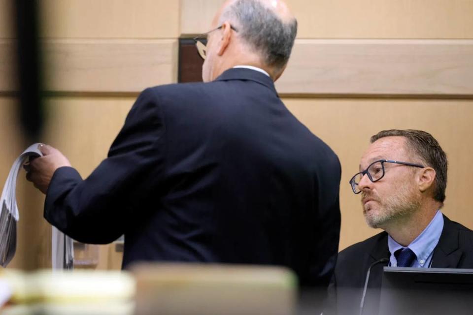 Defense attorney Stuart Adelstein shows Miramar Police detective Mark Moretti documents as he questions him during the trial of Jamell Demons, better known as rapper YNW Melly, at the Broward County Courthouse in Fort Lauderdale on Monday, July 17, 2023. Demons, 22, is accused of killing two fellow rappers and conspiring to make it look like a drive-by shooting in October 2018. (Amy Beth Bennett / South Florida Sun Sentinel)