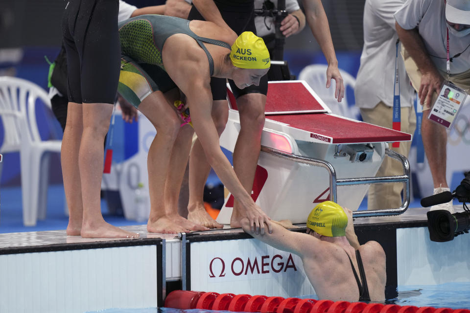 Australian women's 4x100m freestyle relay team's Emma McKeon congratulates teammate Cate Campbell, right, after winning the gold medal at the 2020 Summer Olympics, Sunday, July 25, 2021, in Tokyo, Japan. (AP Photo/Matthias Schrader)