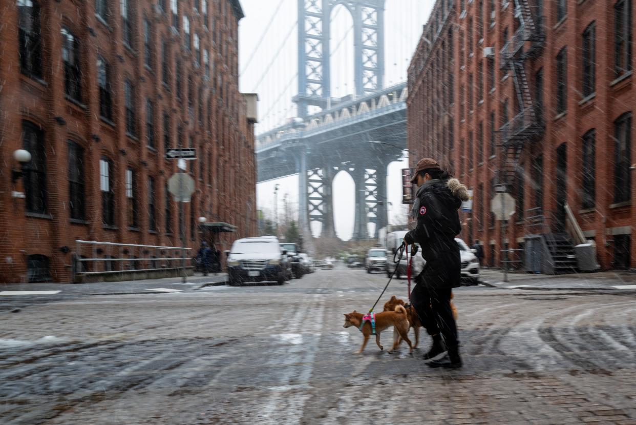 People walk through the blowing snow in Brooklyn as a large winter storm makes its way across the area on February 13, 2024 (Getty Images)