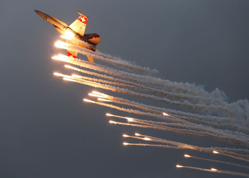 FILE PHOTO: A Swiss Air Force F/A 18 Hornet aircraft releases flare during the Air14 airshow at the airport in Payerne