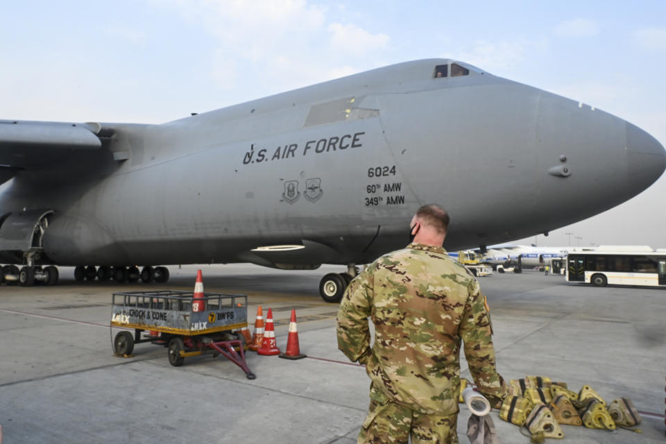 A U.S. Air Force aircraft carrying relief supplies from the United States in the wake of India's COVID-19 situation arrives at the Indira Gandhi International Airport cargo terminal in New Delhi, India, Friday, April 30, 2021. (Prakash Singh/Pool via AP)