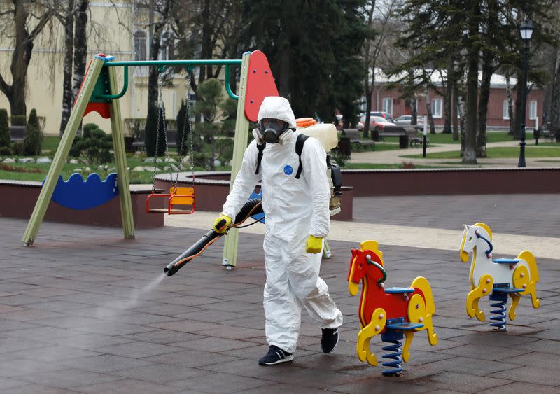 A specialist sprays disinfectant while sanitizing a playground in Stavropol