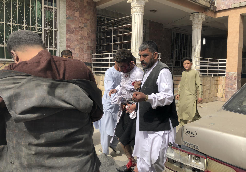 An injured man is rescued after a bomb blast in Mazar-e-Sharif, the capital city of Balkh province, in northern Afghanistan, Saturday, March 11, 2023. A bomb exploded on Saturday during an award ceremony for journalists in the city. (AP Photo/Abdul Saboor Sirat)