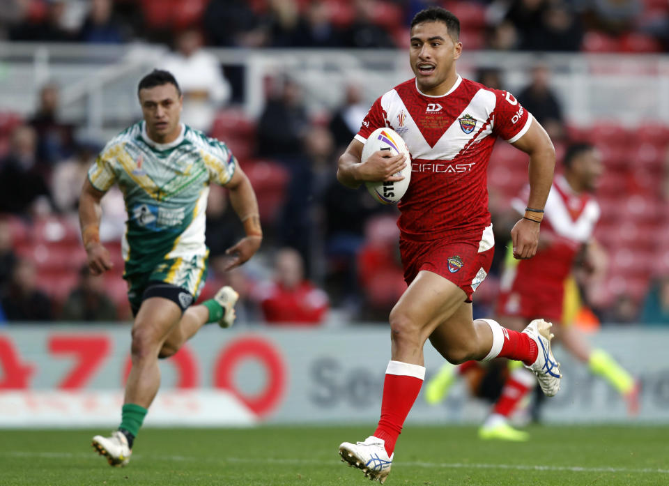 Tonga's Will Penisini on the way to scoring a try during the Rugby League World Cup group D match between Tongo and Cook Islands at the Riverside Stadium in Middlesbrough, England, Sunday Oct. 30, 2022. (Will Matthews/PA via AP)