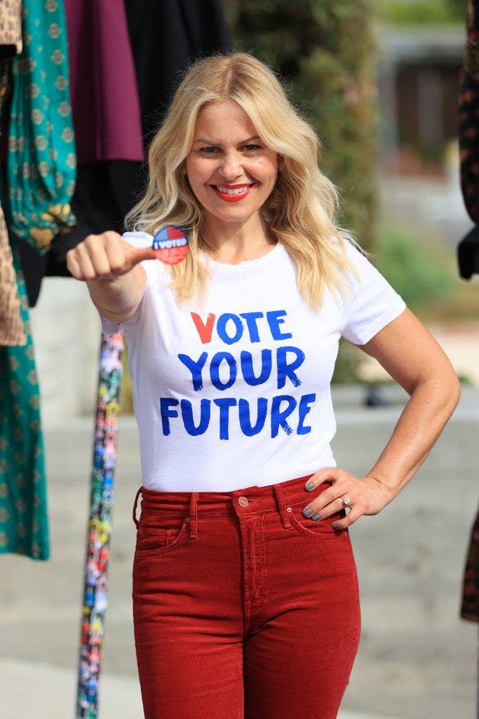 Candace smiles as she wears a shirt that says "Vote your Future"