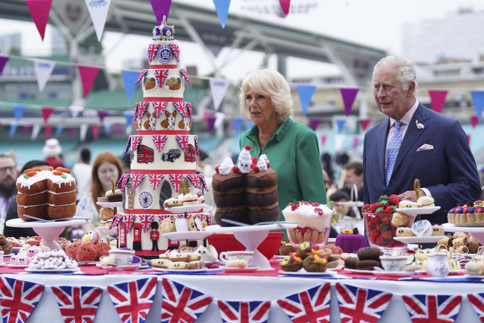 Britain's Prince Charles, right and Camilla, Duchess of Cornwall, as Patron of the Big Lunch, arrive for the Big Jubilee Lunch with tables set up on the pitch at The Oval cricket ground, on the last of four days of celebrations to mark Queen Elizabeth II's Platinum Jubilee, in London, Sunday, June 5, 2022. (Stefan Rousseau/PA via AP)