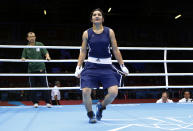 Tajikistan's Mavzuna Chorieva curtsies after winning her quarterfinal Women's Light (60kg) boxing match against China's Dong Cheng at the London Olympic Games August 6, 2012. REUTERS/Murad Sezer (BRITAIN - Tags: SPORT BOXING OLYMPICS) 