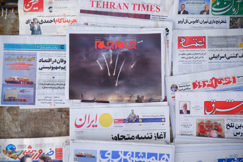 A Jam-e Jam daily newspaper featuring an illustrated image of Iranian surface-to-surface missiles on its front page on Palestine Square in downtown Tehran. Israel on 14 April hailed its air defenses in the face of an unprecedented attack by Iran, saying the systems thwarted 99% of the more than 300 drones and missiles launched toward its territory. Rouzbeh Fouladi/ZUMA Press Wire/dpa