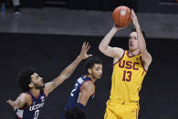 Southern California's Drew Peterson shoots over Connecticut's Jalen Gaffney, left, during the first half of an NCAA college basketball game Thursday, Dec. 3, 2020, in Uncasville, Conn. (AP Photo/Jessica Hill)