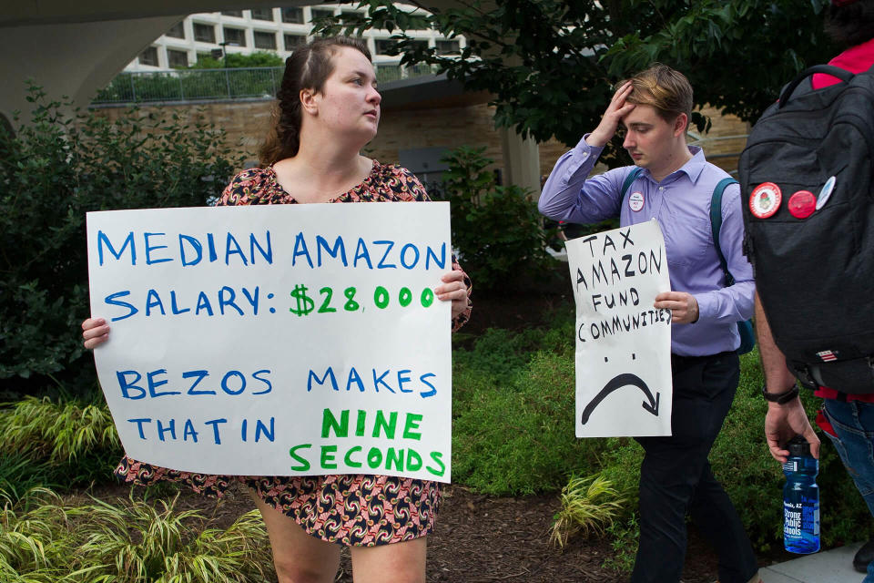 Mandatory Credit: Photo by Cliff Owen/AP/REX/Shutterstock (9881640b)Demonstrators protest against Amazon and Jeff Bezos, Amazon founder and CEO, outside of the hotel where the Economic Club of Washington is having their Milestone Celebration in Washington, .