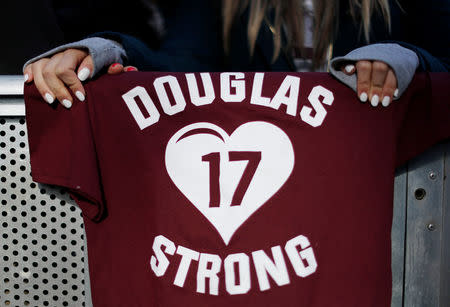 FILE PHOTO: Angela Sitaras, a junior at Marjory Stoneman Douglas High School in Parkland, Florida, holds a sign referring to the 17 students killed in the February 14 mass shooting at her high school as she rallies with thousands of other students and young people at the "March for Our Lives" event demanding gun control in Washington, U.S., March 24, 2018. REUTERS/Jonathan Ernst/File Photo