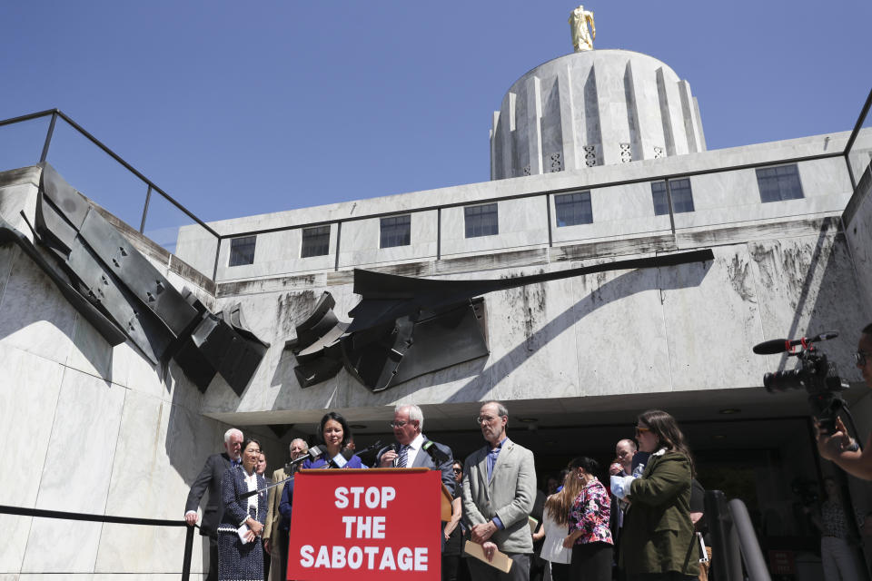 Democratic legislators Rep. Khanh Pham, Rep. David Gomberg and Sen. Michael Dembrow answer questions during a news conference and rally against the Republican Senate walkout at the Oregon State Capitol in Salem, Ore., Tuesday, June 6, 2023. (AP Photo/Amanda Loman)
