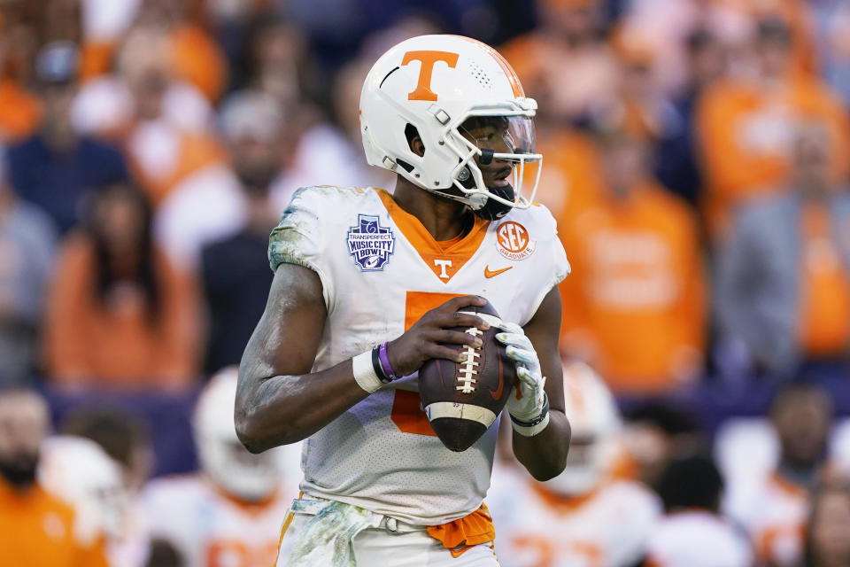 FILE - Tennessee quarterback Hendon Hooker plays against Purdue in the first half of the Music City Bowl NCAA college football game on Dec. 30, 2021, in Nashville, Tenn. Hooker goes into his sixth season as the starter. He earned the job last season after coming off the bench to set program records for a 181.4 passing efficiency and a 68% completion percentage. Hooker also threw 31 touchdowns with only three interceptions. (AP Photo/Mark Humphrey, File)