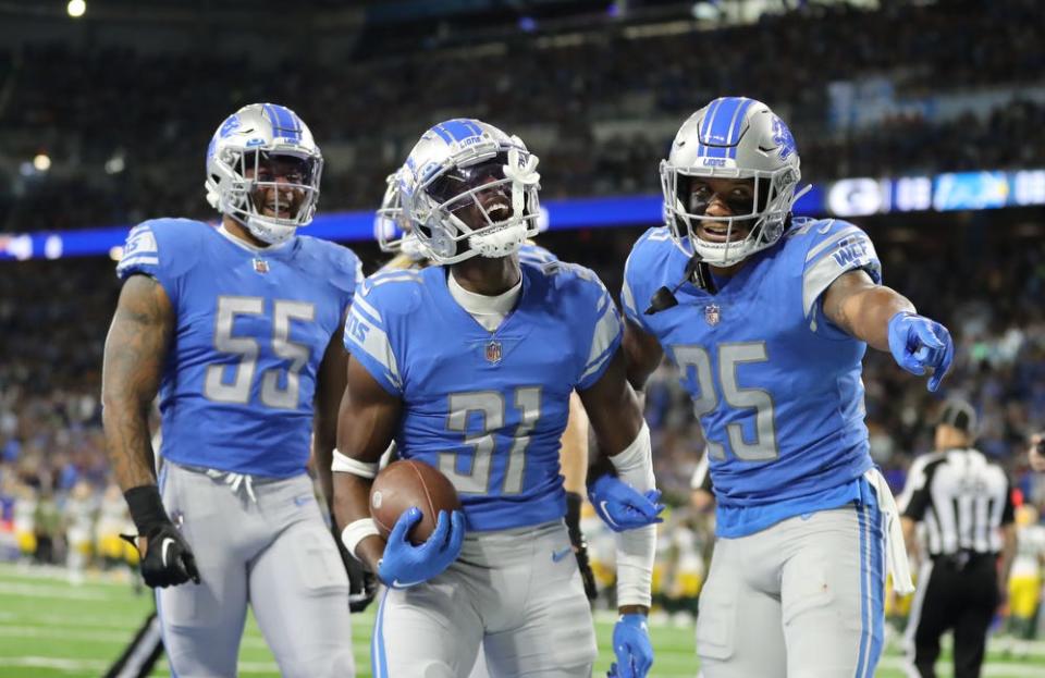 Nov 6, 2022; Detroit, Michigan, USA;  Detroit Lions safety Kerby Joseph (31) celebrates his interception with linebacker Derrick Barnes (55) and safety Will Harris (25) during first half action at Ford Field. Mandatory Credit: Kirthmon F. Dozier-USA TODAY Sports