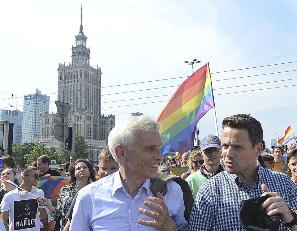 Warsaw Mayor Rafal Trzaskowski, right, and former Warsaw Mayor Marcin Swiecicki, speak as they walk during the gay pride parade, in Warsaw, Poland, Saturday, June 8, 2019. It brought thousands of people to the streets of Warsaw at a time when the LGBT rights movement in Poland is targeted by hate speeches and a government campaign depicting it as a threat to families and society. (AP Photo/Czarek Sokolowski)